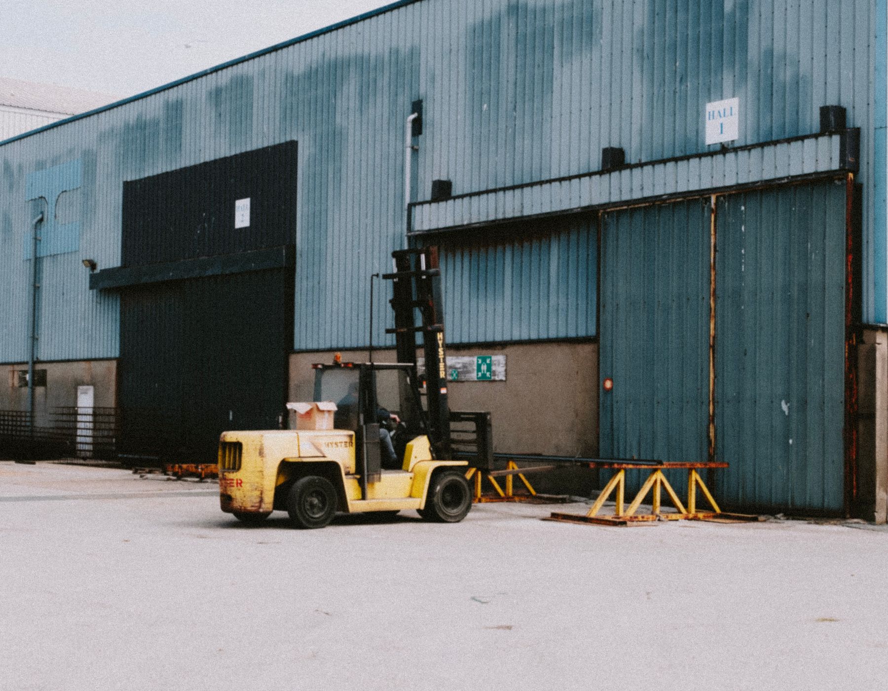 Forklift staged outside a logistics warehouse